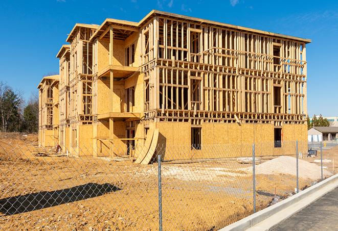 workers protected by temporary barrier fence during building maintenance in Waukesha, WI